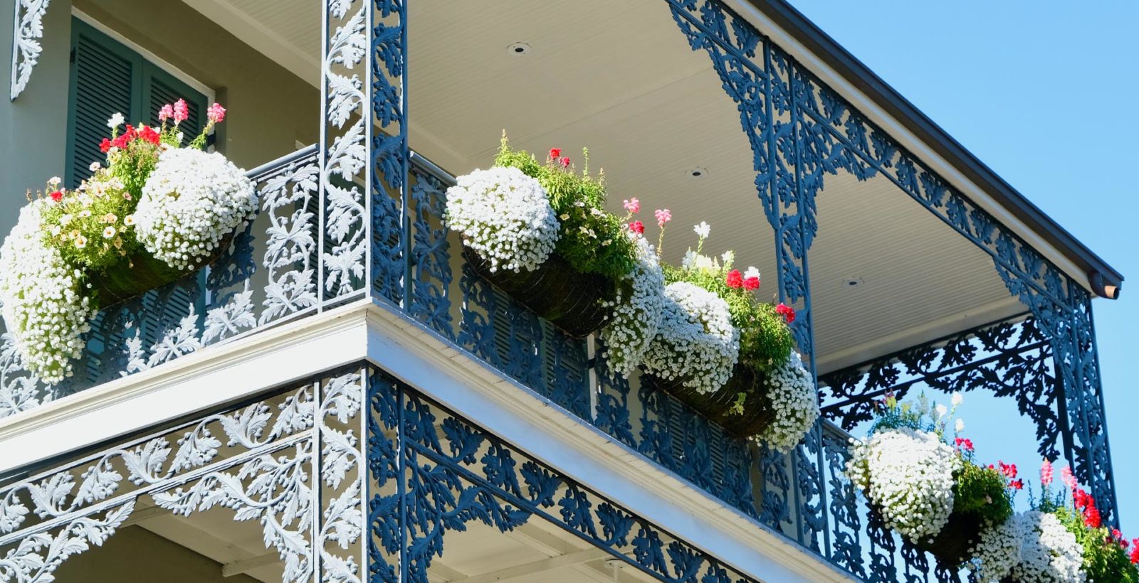 second story balcony with filled with flowers
