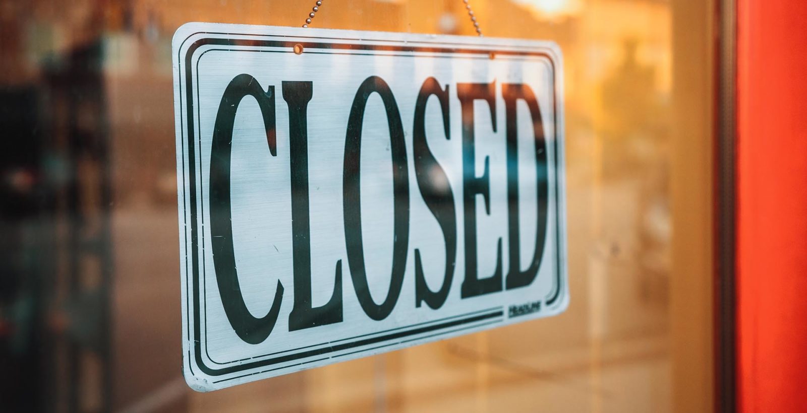 "Closed" sign on a business storefront